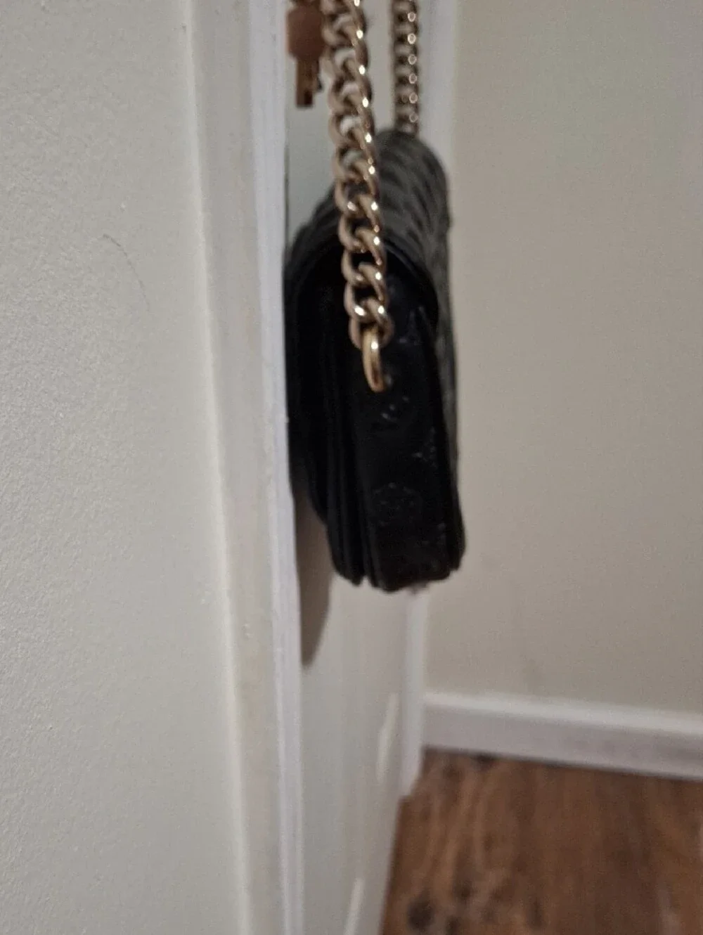GUESS Black Embossed Leather Shoulder Bag with Gold Chain and Charm Accent